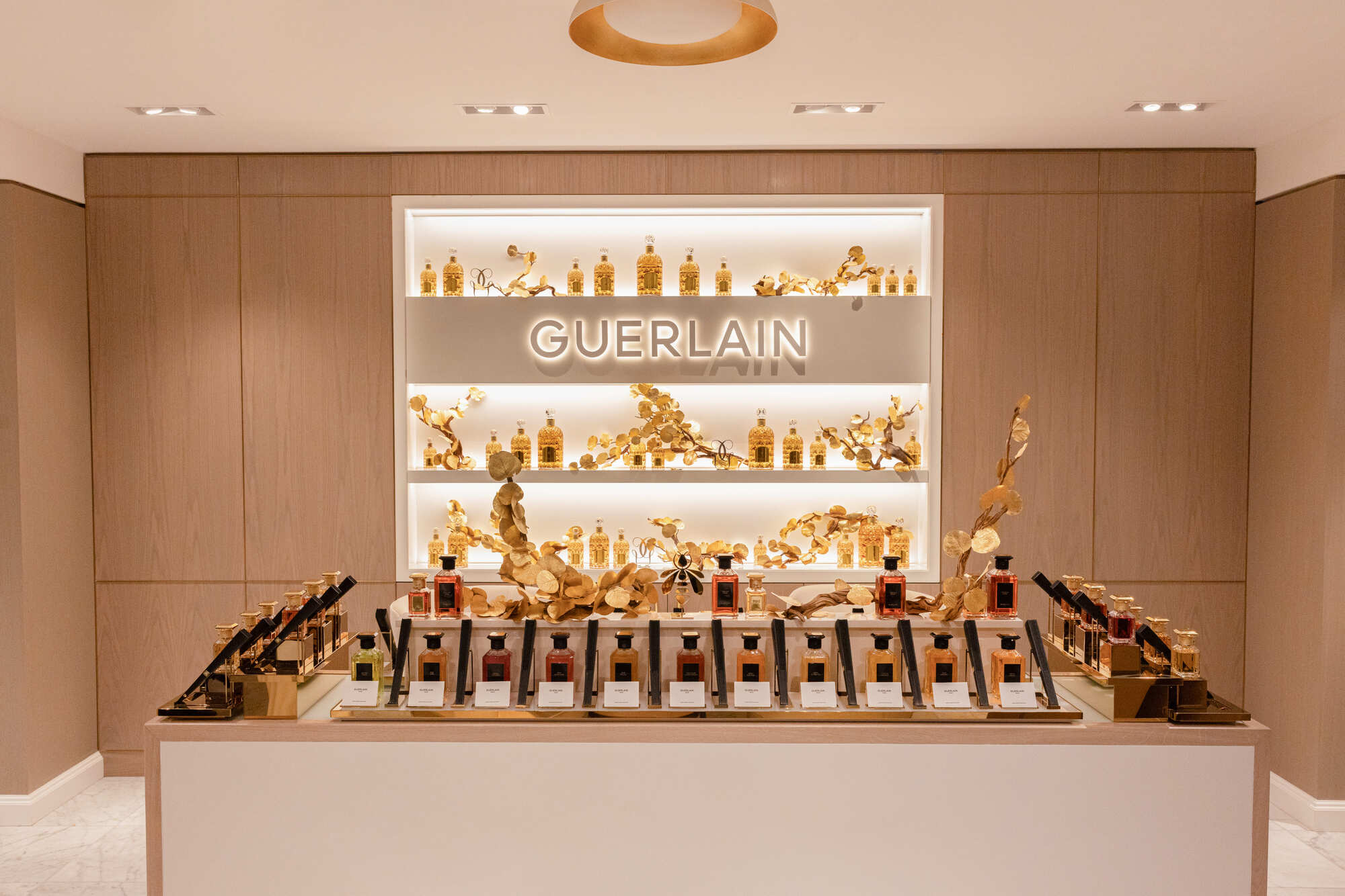 a brightly lit spa area with a Guerlain sign in the background