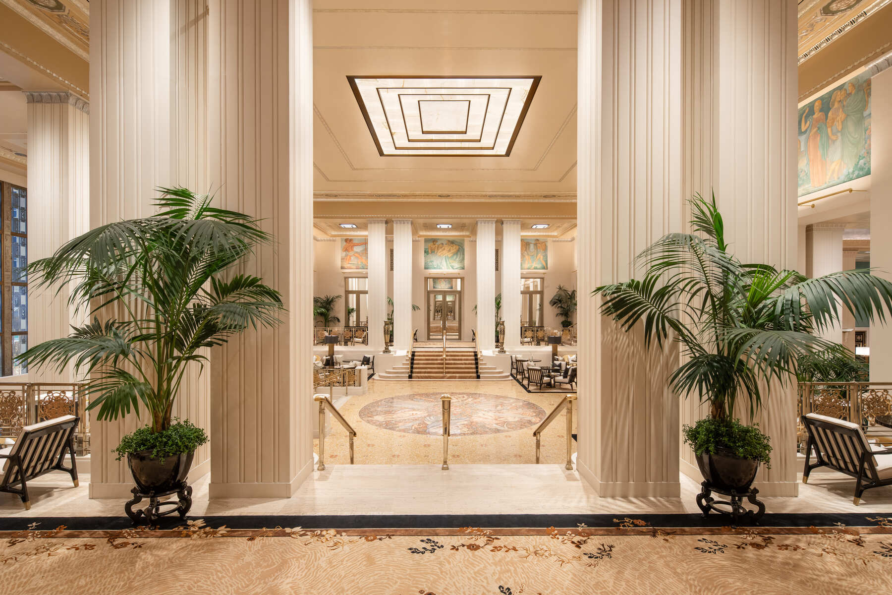 bright lit lobby with green plants outlining the entryway