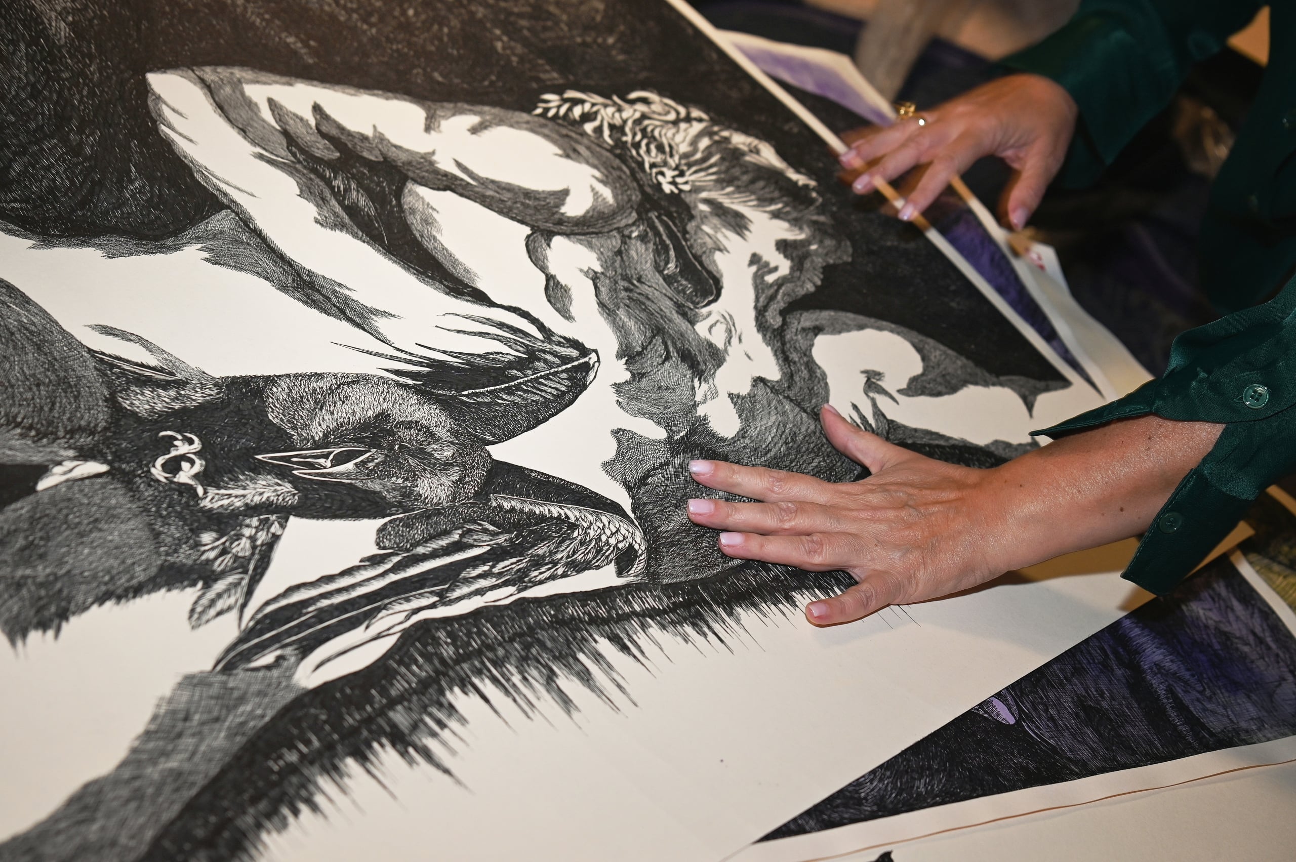 two hands on an art canvas